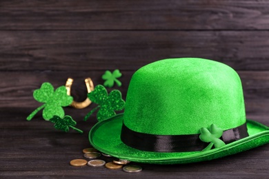 Photo of Leprechaun's hat and St. Patrick's day decor on black wooden table