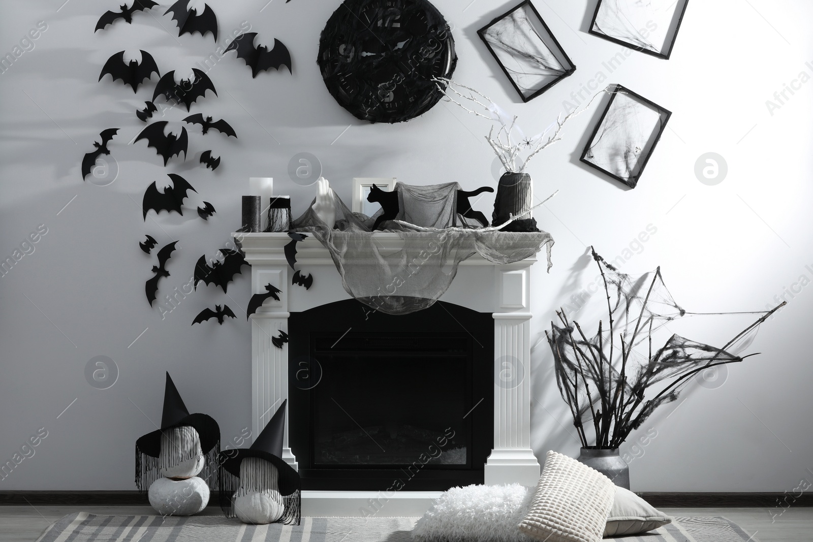 Photo of Stylish room with fireplace decorated for Halloween