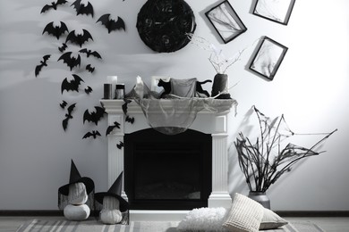 Photo of Stylish room with fireplace decorated for Halloween