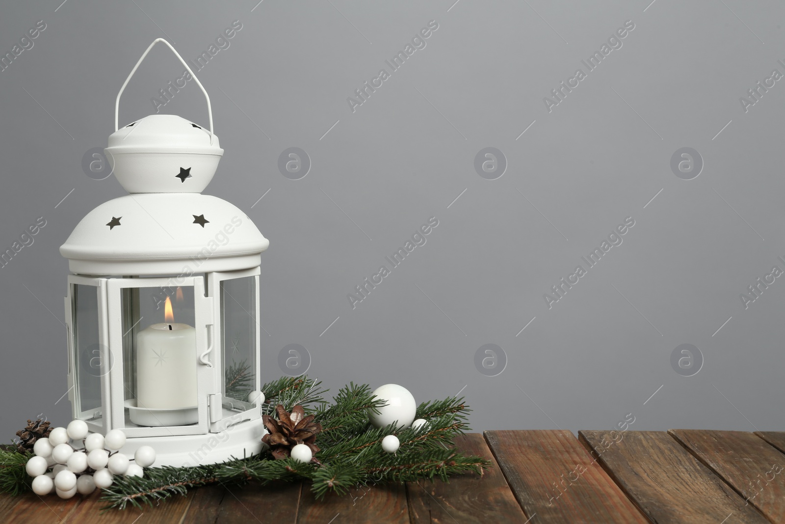 Photo of Lantern and Christmas decorations on grey background, space for text