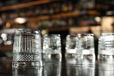 Photo of Empty clean glass on counter in bar. Space for text