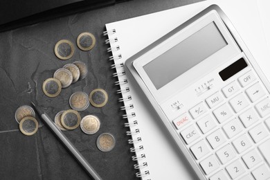 Photo of Calculator, notebook and money on dark grey table, flat lay. Tax accounting