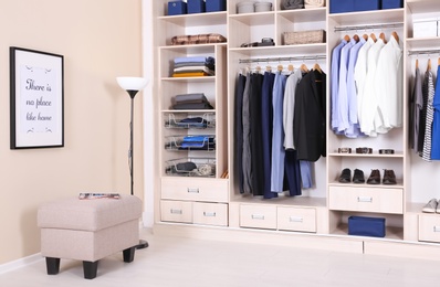 Room interior with wardrobe and stylish ottoman chair