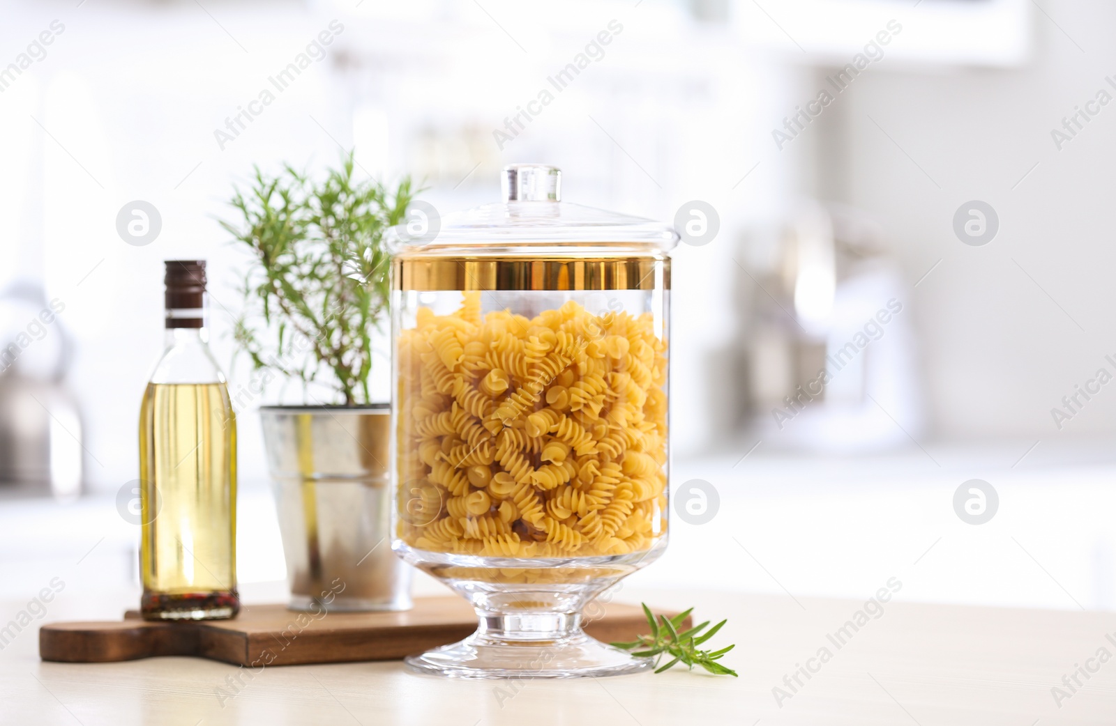 Photo of Raw pasta on wooden table in modern kitchen