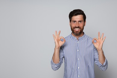 Portrait of bearded man on grey background. Space for text