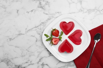 Photo of Plate of tasty strawberry jelly served on marble table, flat lay with space for text