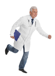 Senior doctor with clipboard running on white background