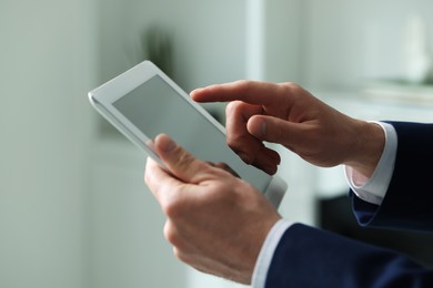 Photo of Closeup view of man using new tablet indoors