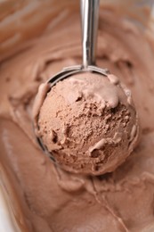 Photo of Taking tasty chocolate ice cream with scoop as background, closeup