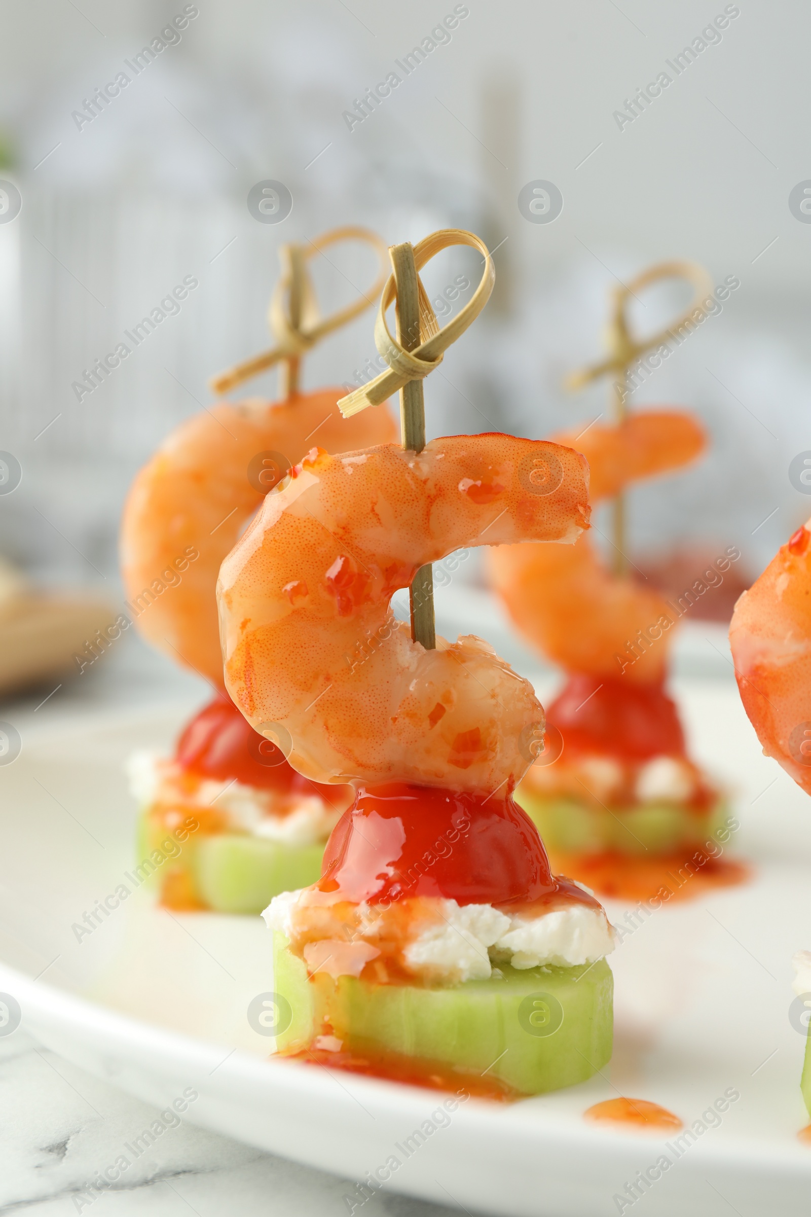 Photo of Tasty canapes with shrimps, vegetables and cream cheese on white table, closeup