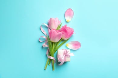 Flat lay composition of tulips on blue background. International Women's Day