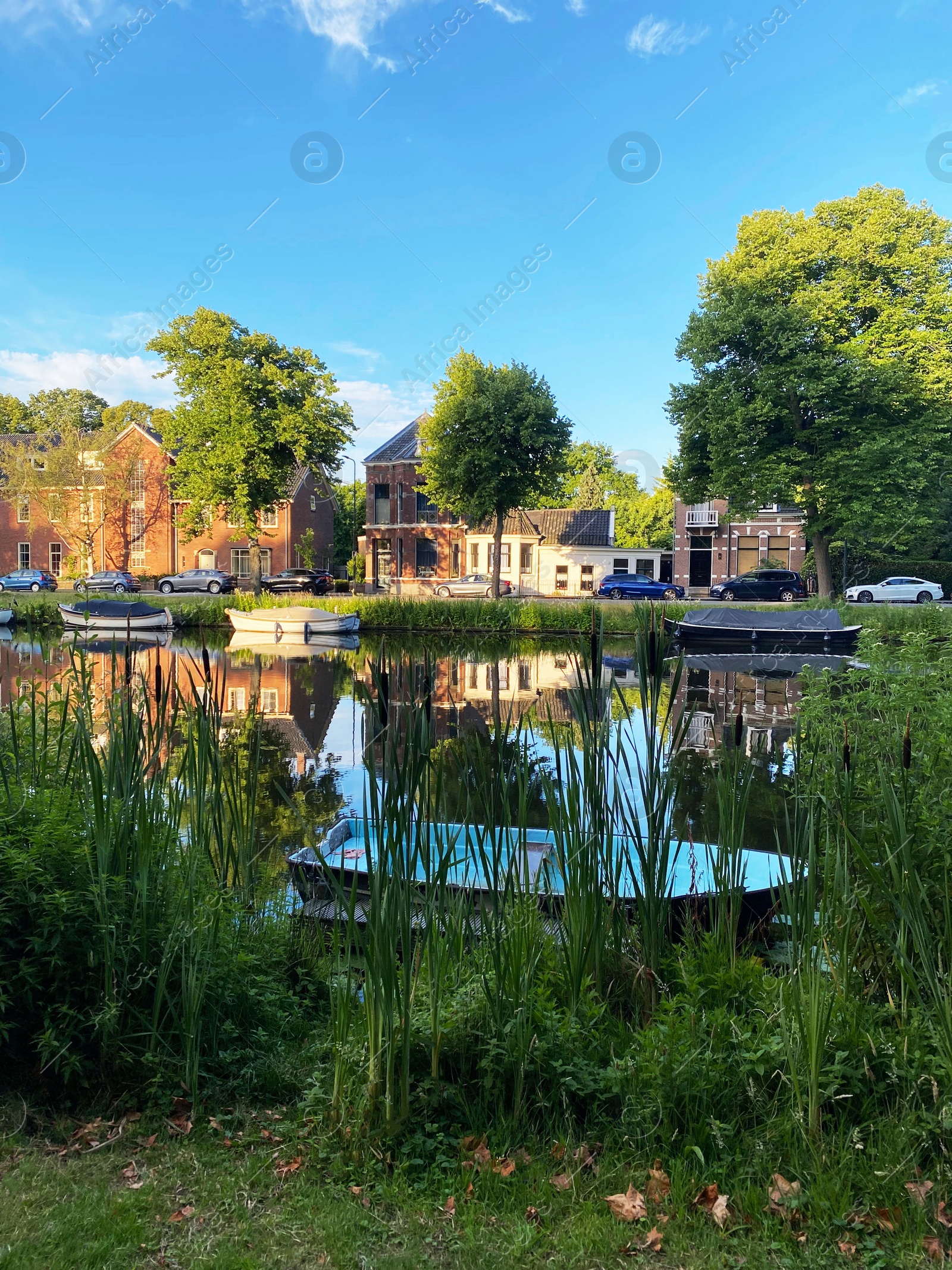 Photo of Beautiful view of street near river with moored boats