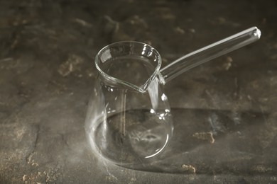 Empty glass turkish coffee pot on grey table