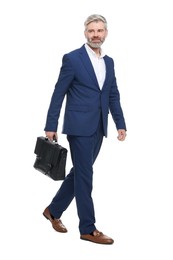 Mature businessman with briefcase walking on white background