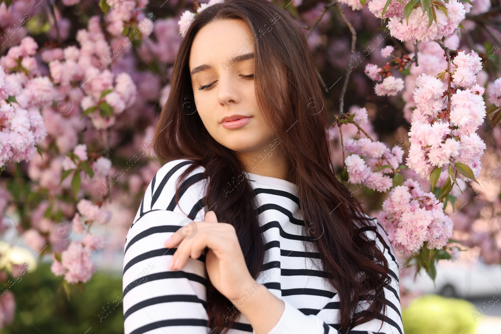 Photo of Beautiful woman near blossoming tree on spring day