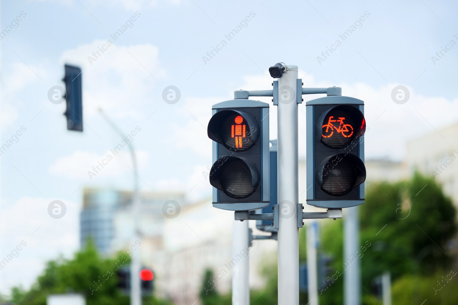 Photo of Pedestrian and bicycle traffic light on city street, space for text