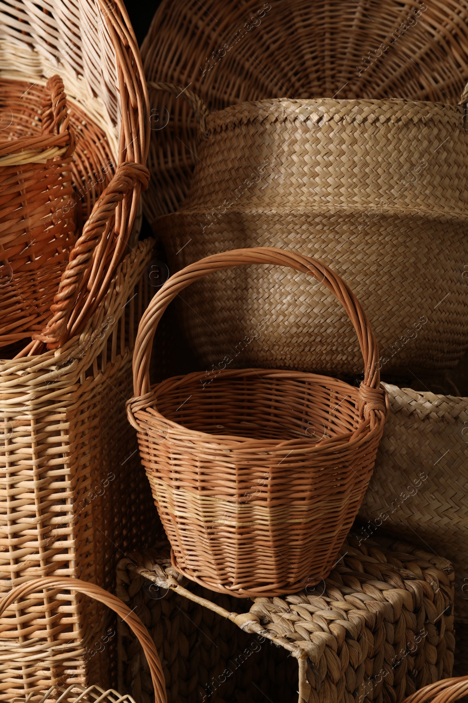 Photo of Many different wicker baskets made of natural material as background, closeup