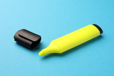 Photo of Bright yellow marker on light blue background