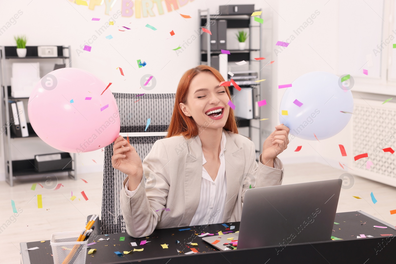 Photo of Young woman having fun during office party at workplace