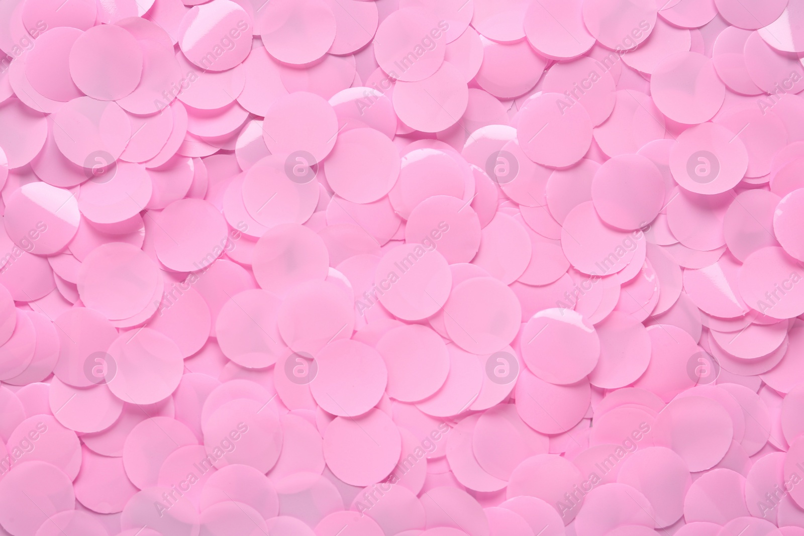 Photo of Many pink confetti as background, top view