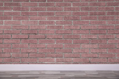 Room with brick wall and wooden floor