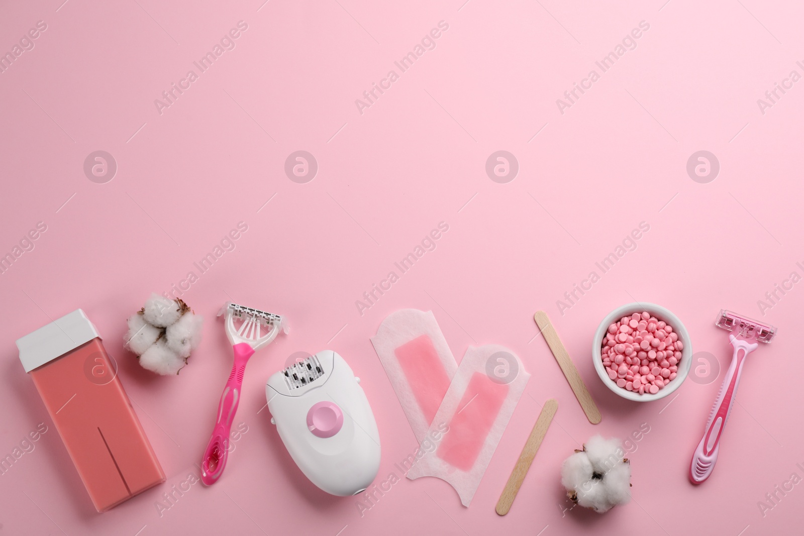 Photo of Set of epilation tools and products on pink background, flat lay. Space for text