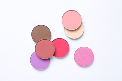 Different beautiful eye shadows on white background, flat lay