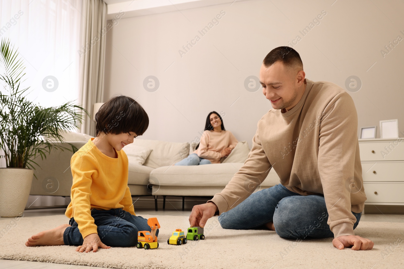 Photo of Father and his son playing together at home