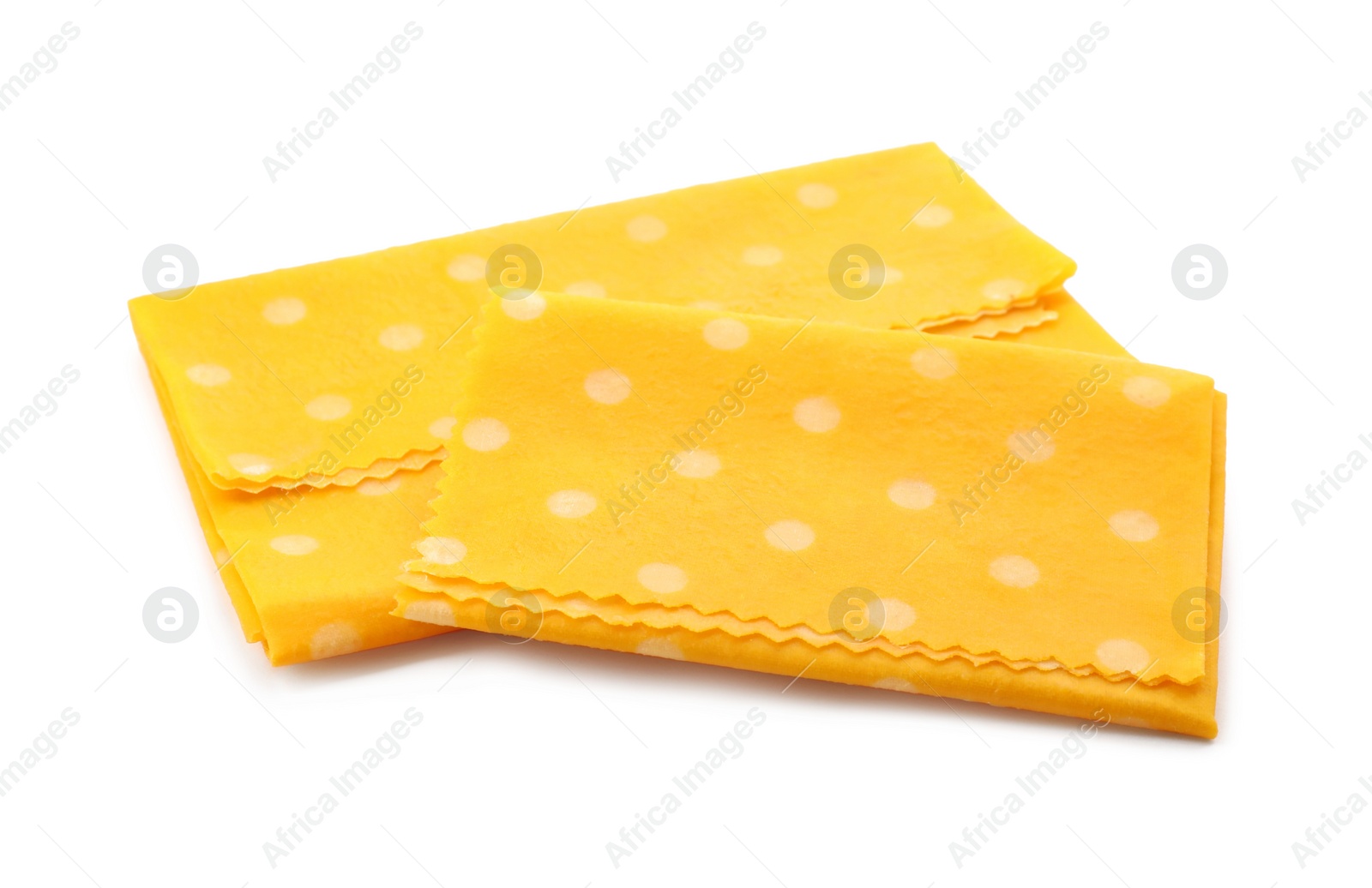 Photo of Reusable beeswax food wraps on white background