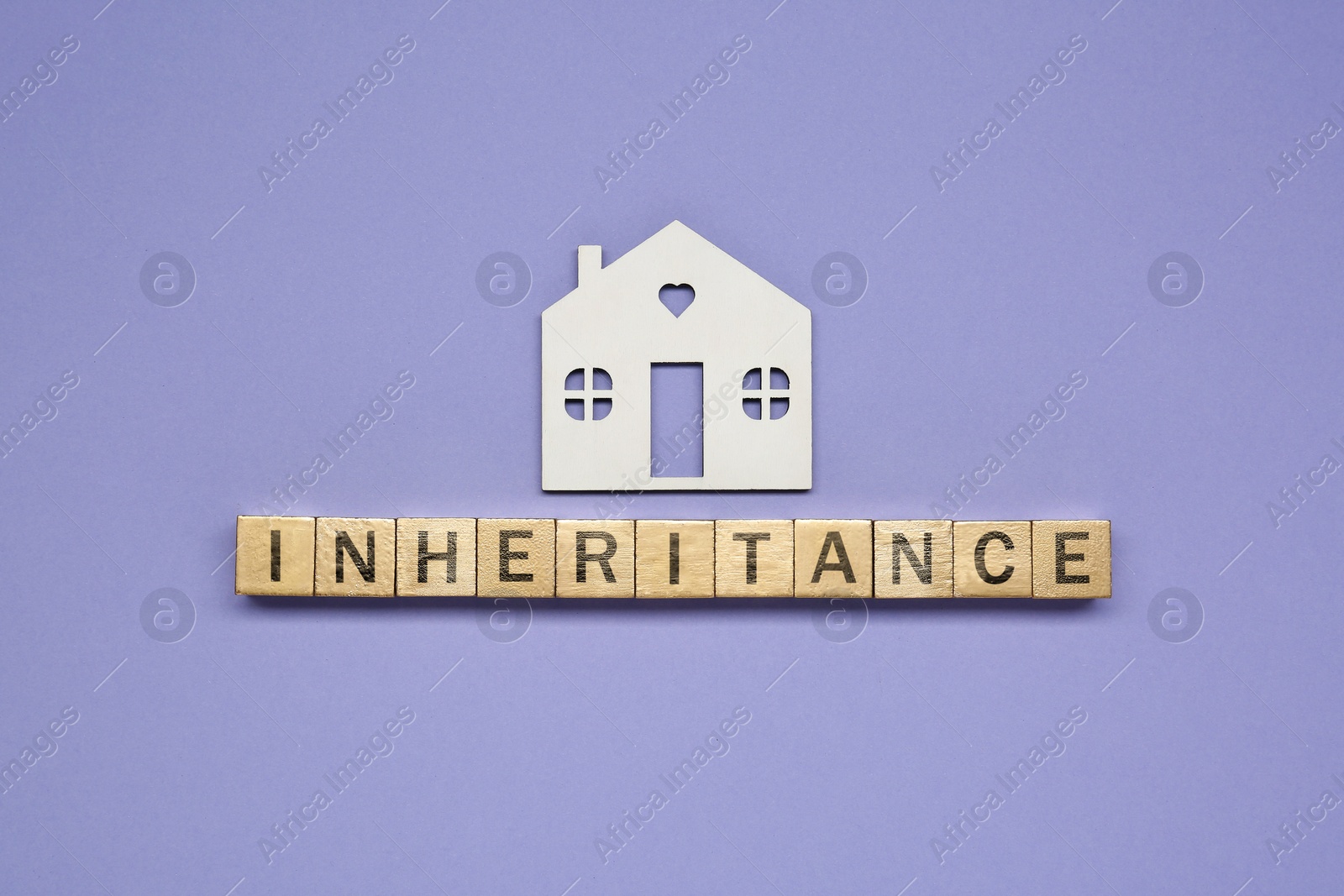 Photo of Word Inheritance made with wooden cubes and house model on color background, flat lay