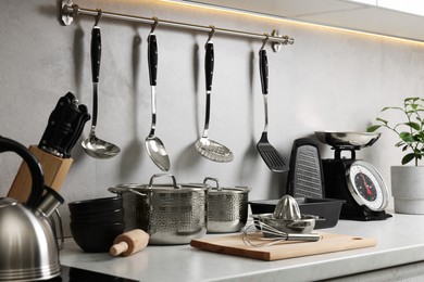 Photo of Set of different utensils on countertop in kitchen