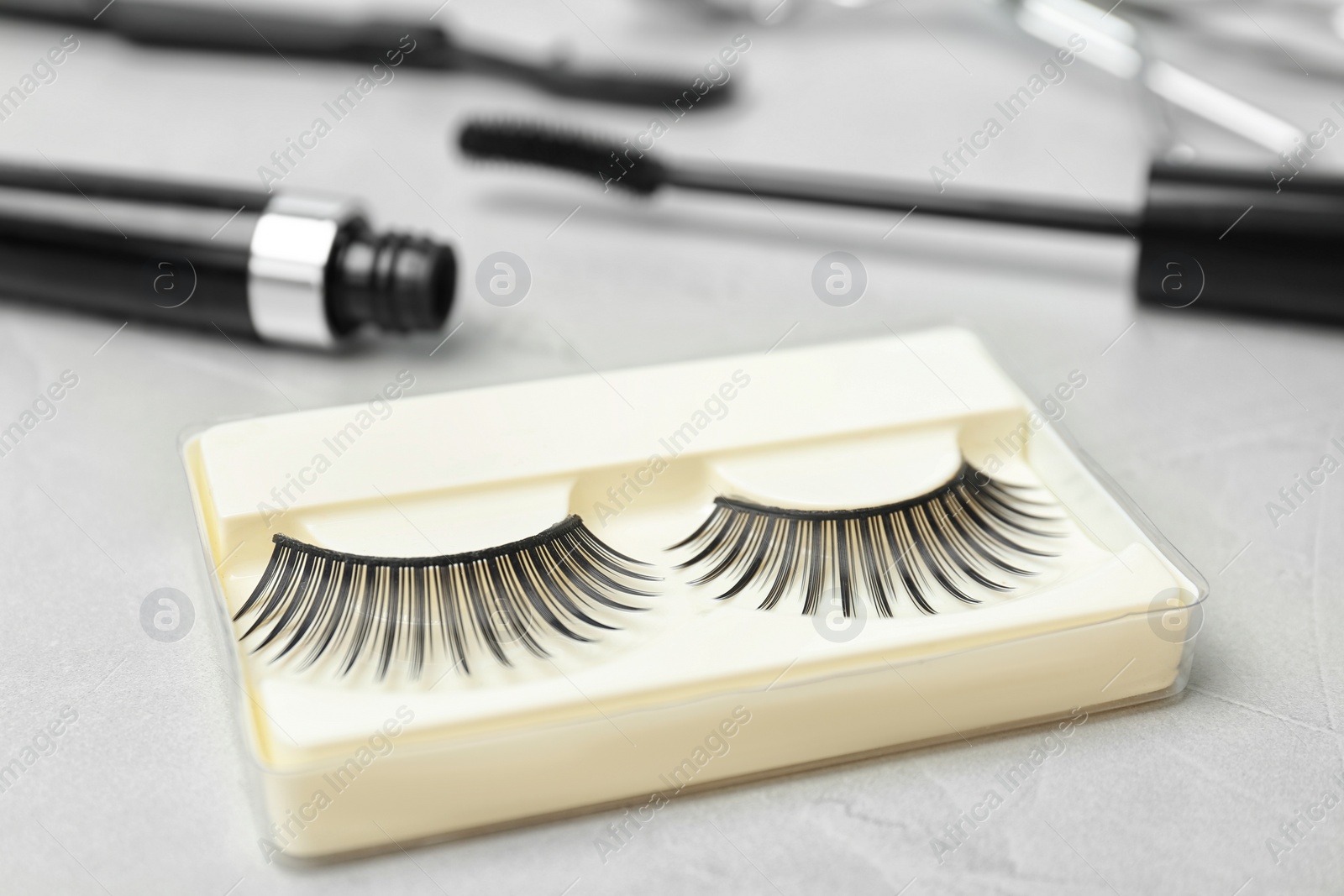 Photo of False eyelashes on grey background, closeup