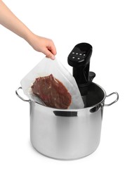 Photo of Woman putting vacuum packed meat in pot with sous vide cooker on white background, closeup