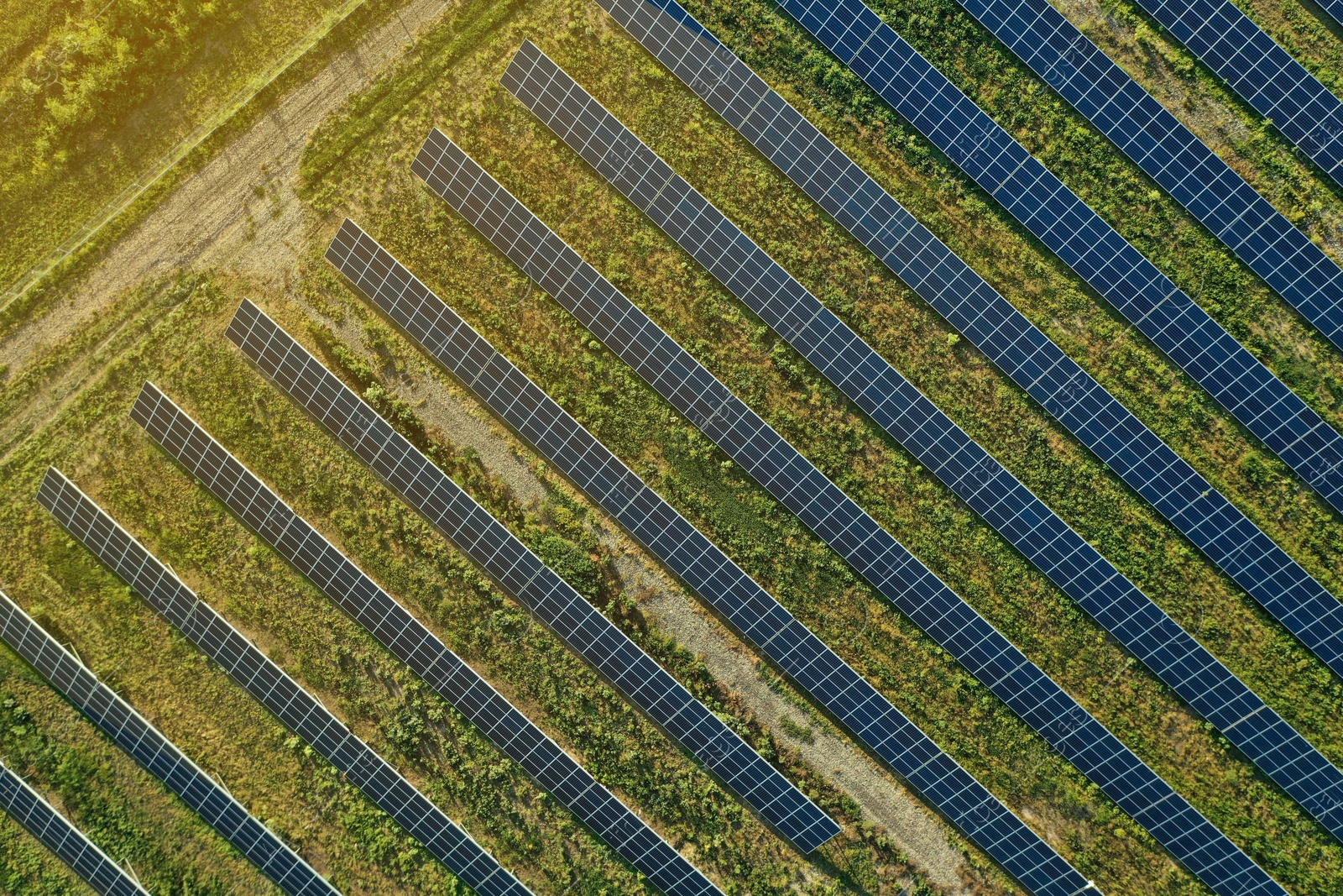 Photo of Solar panels installed outdoors, aerial top view. Alternative energy source