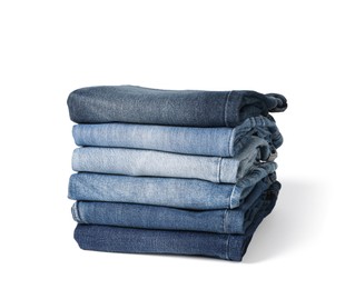 Image of Stack of different folded jeans isolated on white