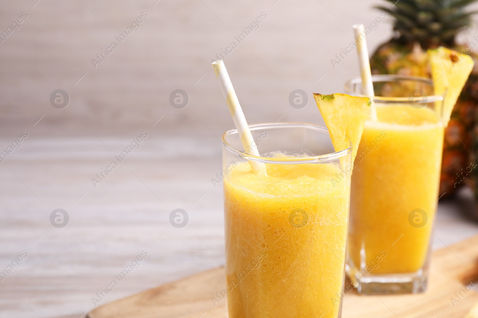 Photo of Tasty pineapple smoothie on table. Space for text