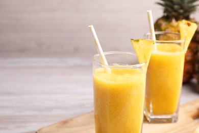 Photo of Tasty pineapple smoothie on table. Space for text