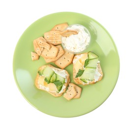 Delicious crackers with cream cheese, cucumber and parsley on white background, top view