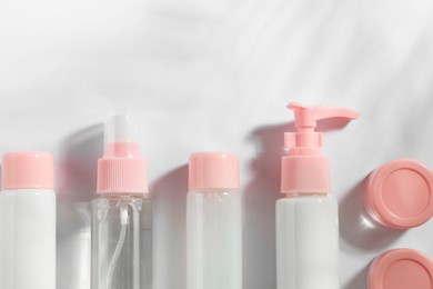 Photo of Cosmetic travel kit on white background, top view