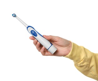 Photo of Woman holding electric toothbrush on white background, closeup