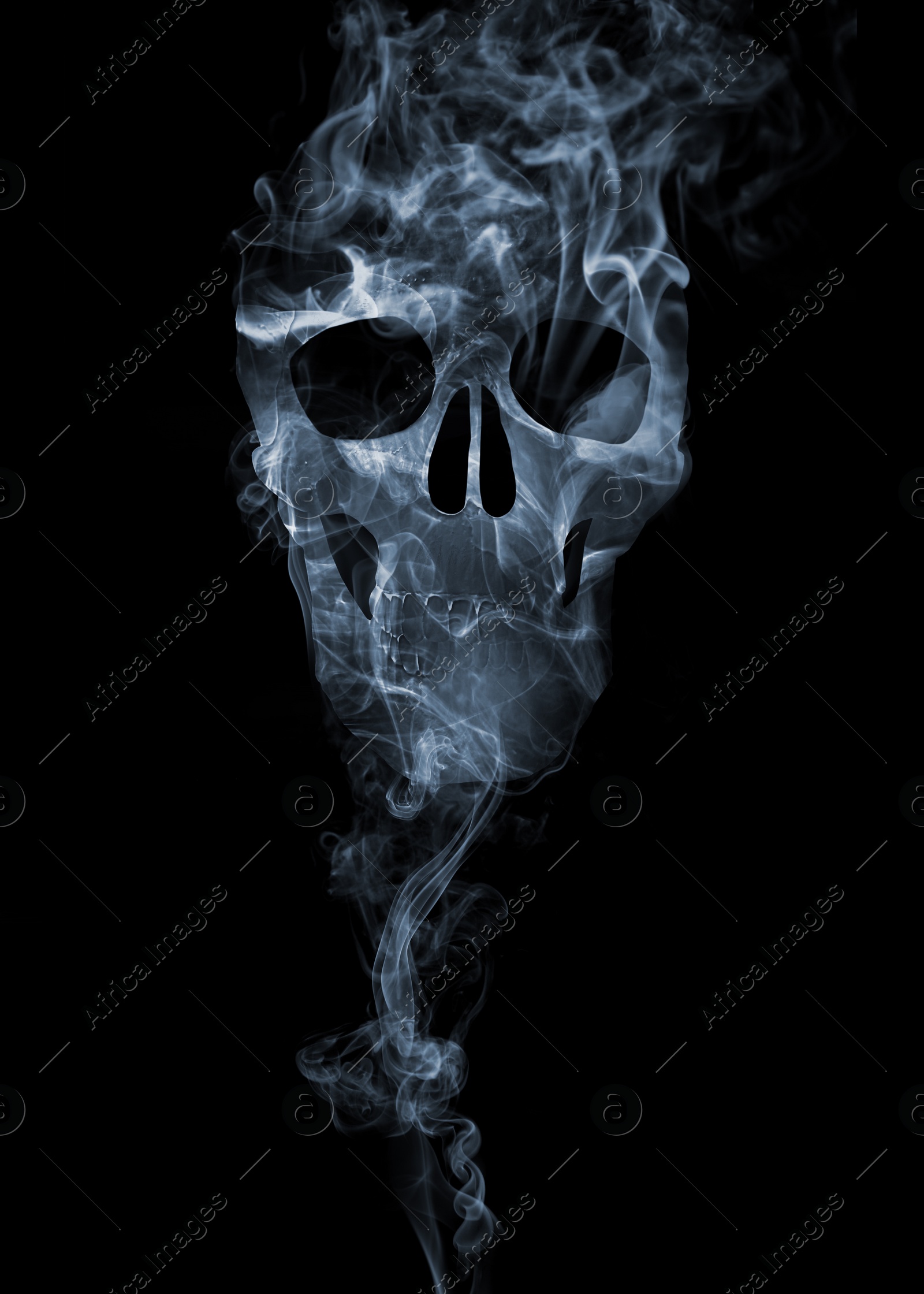 Image of Silhouette of scary skull made of smoke in darkness