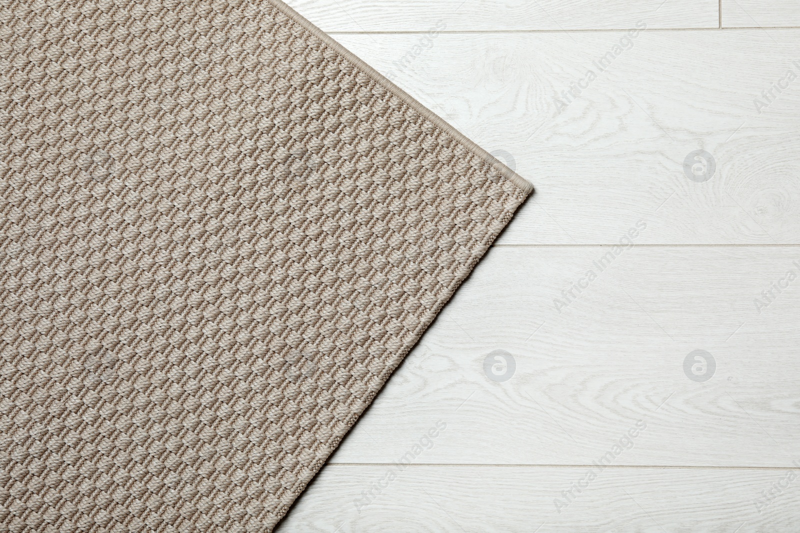 Photo of Woven mat on wooden background, top view with space for text