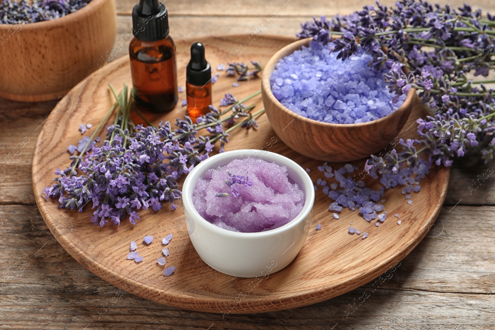 Photo of Plate with natural cosmetic products and lavender flowers on wooden table