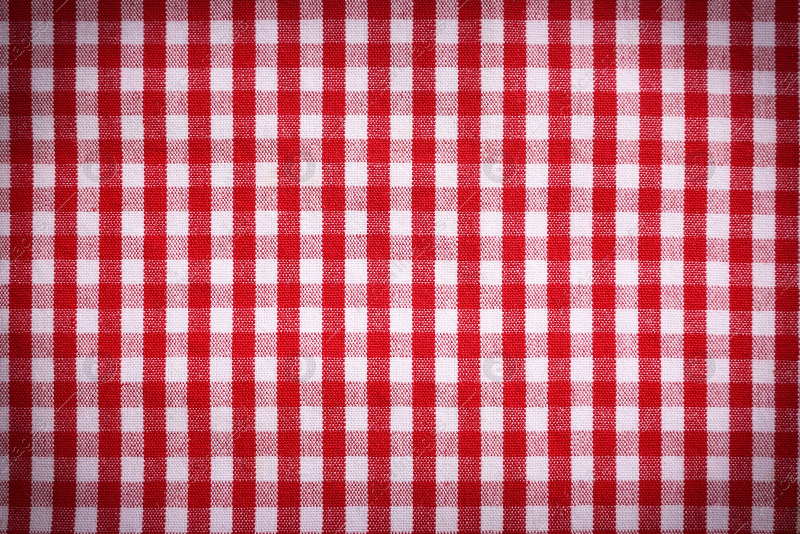 Image of Red and white tablecloth as background, vignette effect