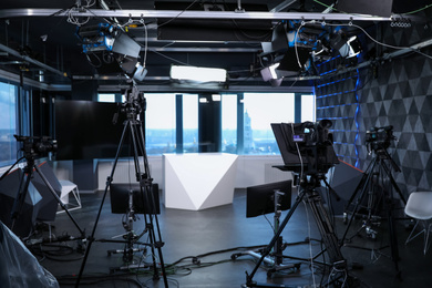 Photo of Modern video recording studio with professional cameras