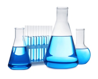 Photo of Set of laboratory glassware with blue liquid on white background