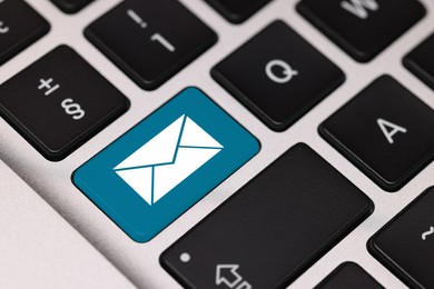 Image of Email. Light blue button with illustration of envelope on computer keyboard, closeup