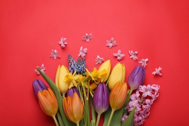 Beautiful bouquet with different flowers on red background, flat lay