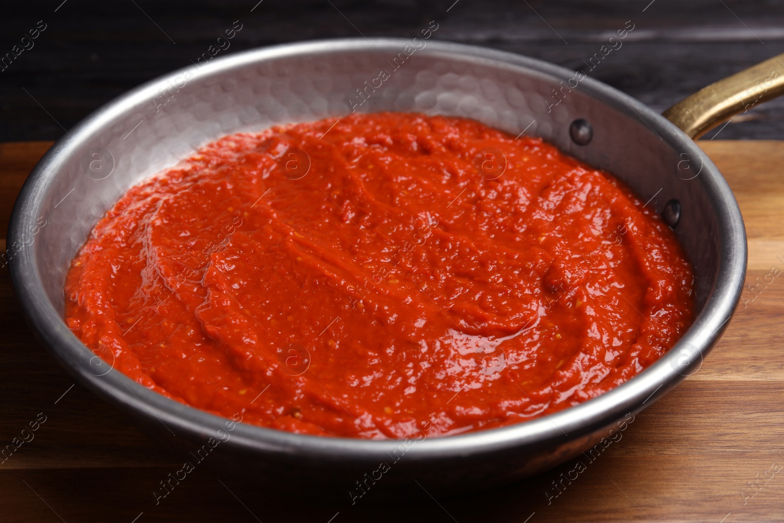 Photo of Delicious tomato sauce in pan, closeup view