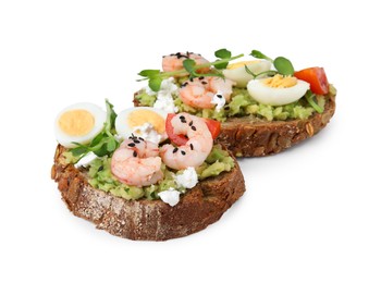 Photo of Delicious sandwiches with guacamole, shrimps and eggs on white background